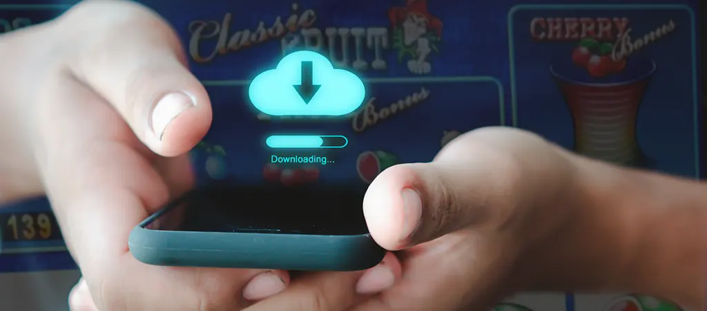 K&eacute;zben tartott mobiltelefonon r&eacute;gi nyerőg&eacute;pes j&aacute;t&eacute;kok let&ouml;lt&eacute;se folyamatban, k&eacute;pernyőn felhő ikon &eacute;s let&ouml;lt&eacute;s jelz&eacute;s